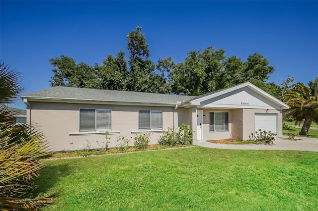 single story home with a front yard and a garage