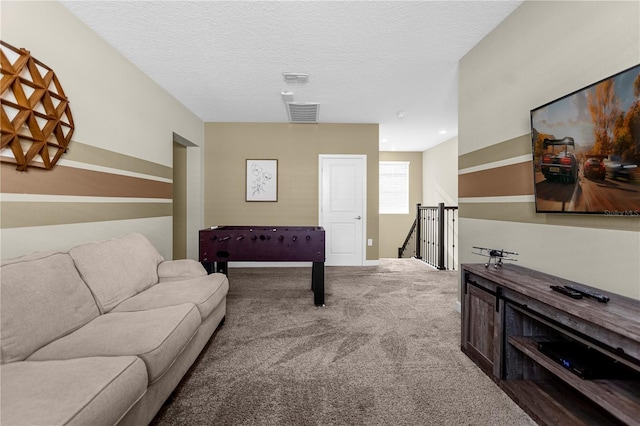 living room with a textured ceiling and carpet floors