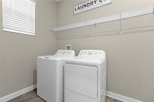 laundry room with light tile floors and washer and clothes dryer