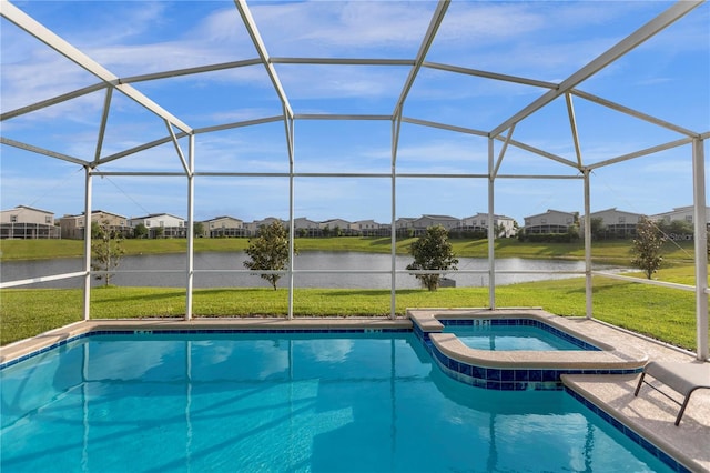 view of pool with a yard, an in ground hot tub, and glass enclosure