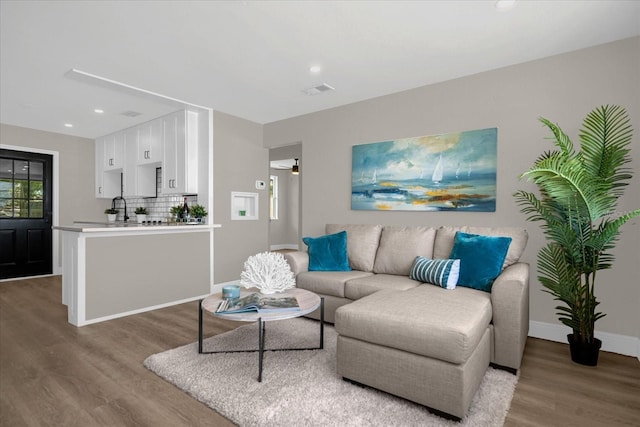 living room featuring hardwood / wood-style flooring and ceiling fan