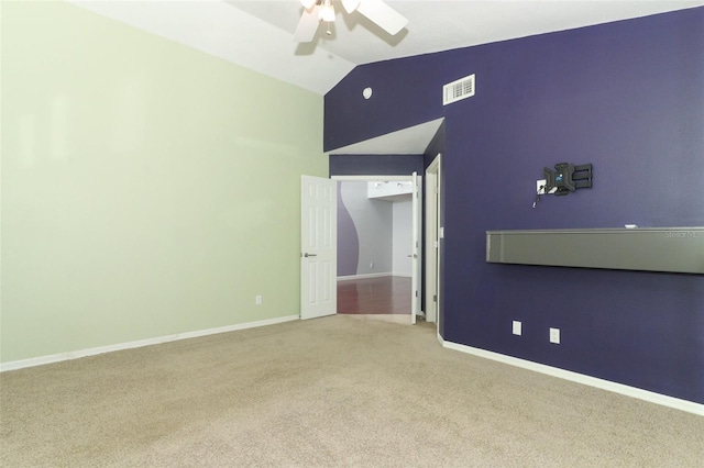 unfurnished bedroom featuring carpet flooring, vaulted ceiling, and ceiling fan