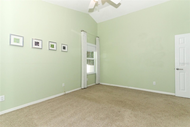 empty room with ceiling fan, light colored carpet, and lofted ceiling