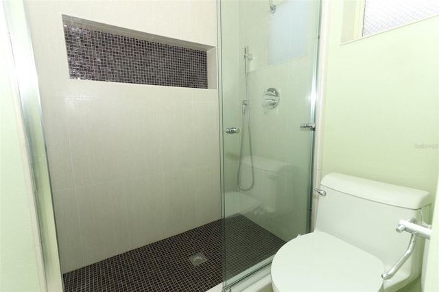 bathroom featuring toilet and walk in shower