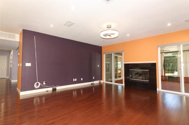 unfurnished living room with dark hardwood / wood-style floors