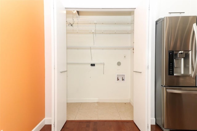 washroom with washer hookup and light tile patterned floors