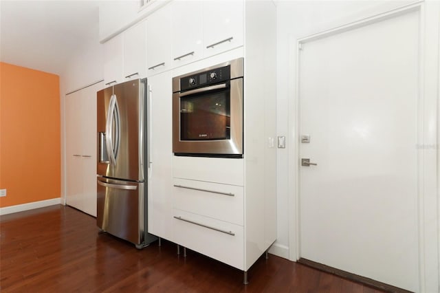 kitchen with white cabinetry, dark hardwood / wood-style floors, and appliances with stainless steel finishes