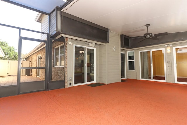 unfurnished sunroom featuring ceiling fan