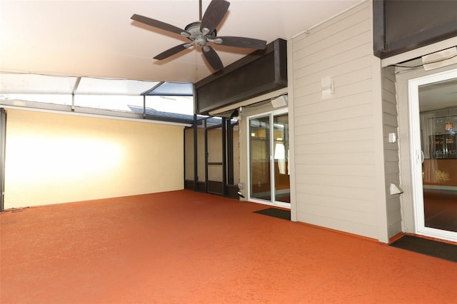 interior space featuring ceiling fan and dark carpet