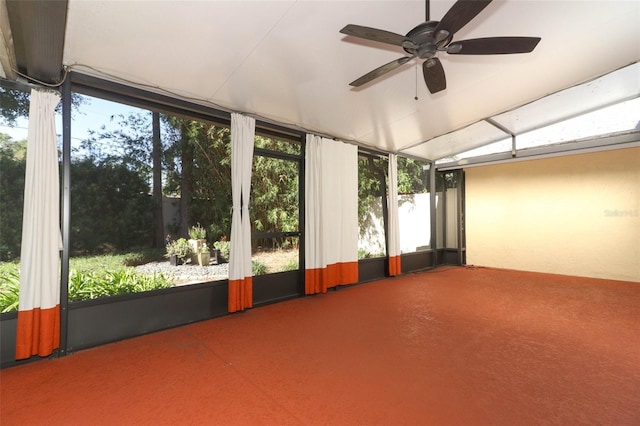 unfurnished sunroom featuring ceiling fan