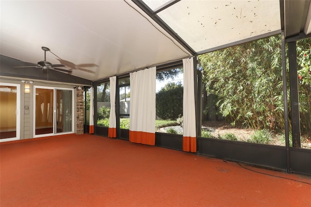 unfurnished sunroom featuring ceiling fan and vaulted ceiling