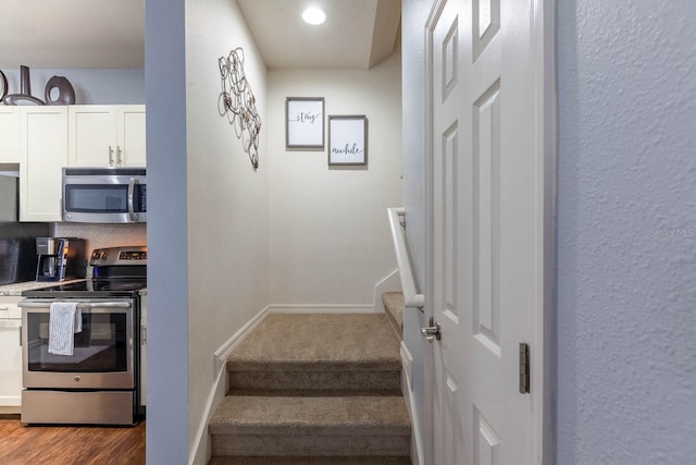 stairs featuring wood-type flooring