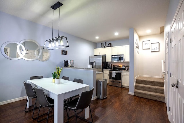 dining room with dark hardwood / wood-style flooring