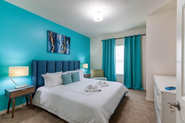 bedroom with carpet and a textured ceiling