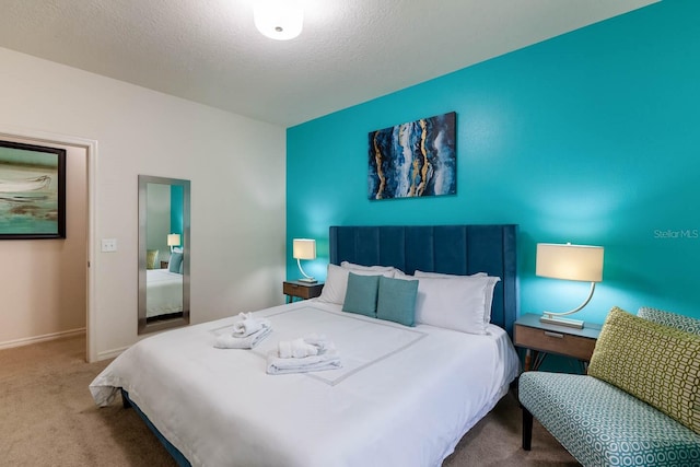 bedroom with carpet and a textured ceiling