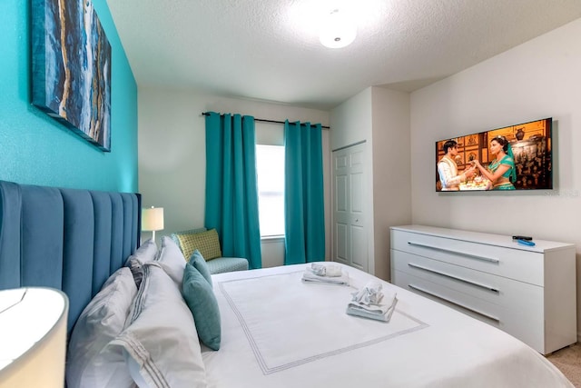 carpeted bedroom with a textured ceiling