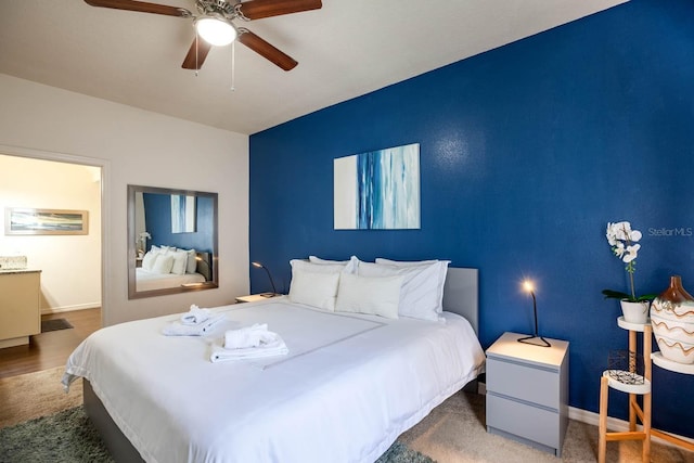 bedroom with ceiling fan and hardwood / wood-style flooring