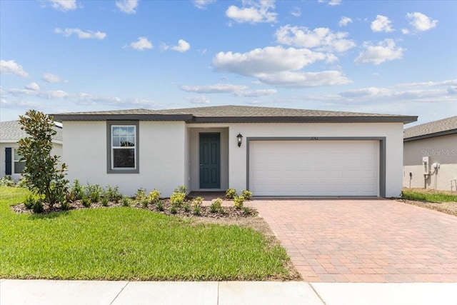 ranch-style home featuring a garage and a front yard