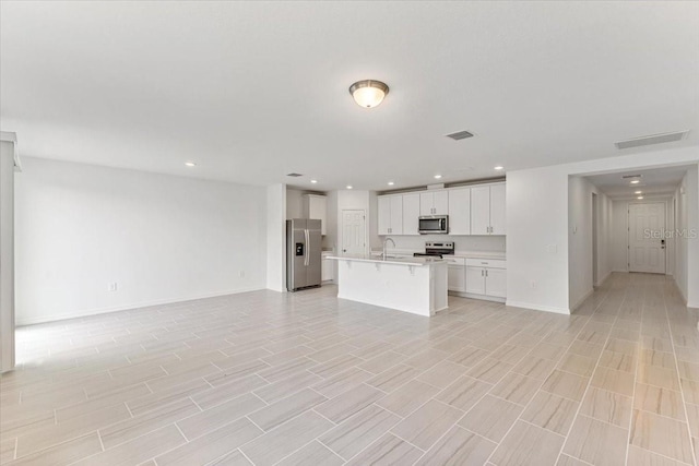 unfurnished living room with sink