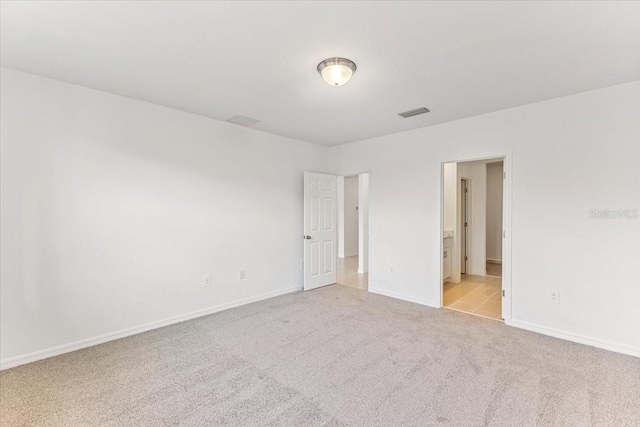 empty room featuring light carpet