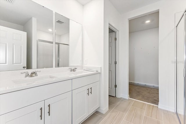 bathroom featuring vanity and a shower with door