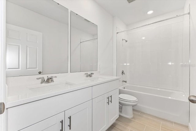 full bathroom with vanity, toilet, and tiled shower / bath