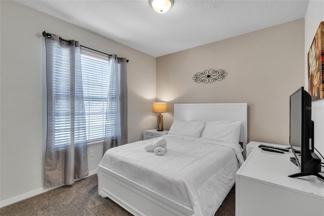 bedroom with dark carpet and multiple windows