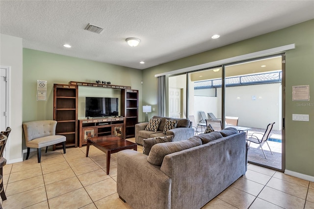 living room with light tile flooring and a textured ceiling