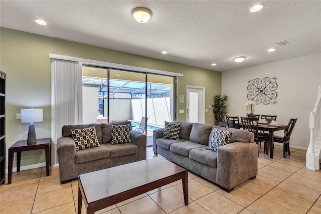 tiled living room with plenty of natural light and a textured ceiling