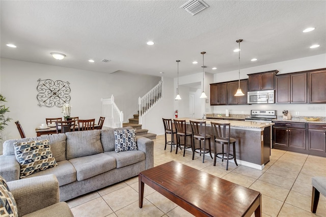 tiled living room featuring a textured ceiling