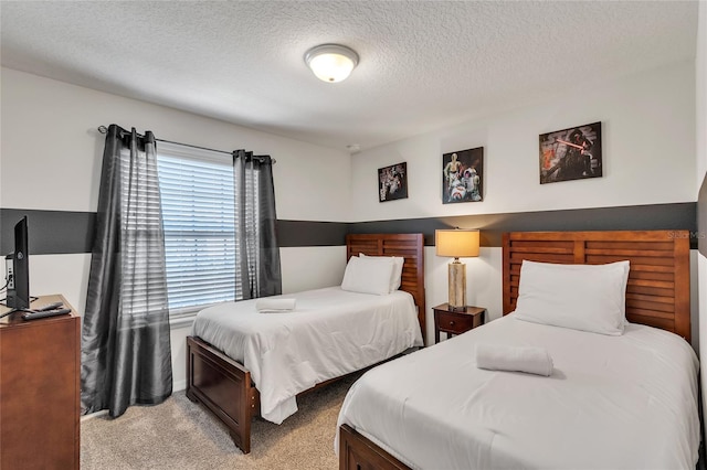 carpeted bedroom featuring a textured ceiling