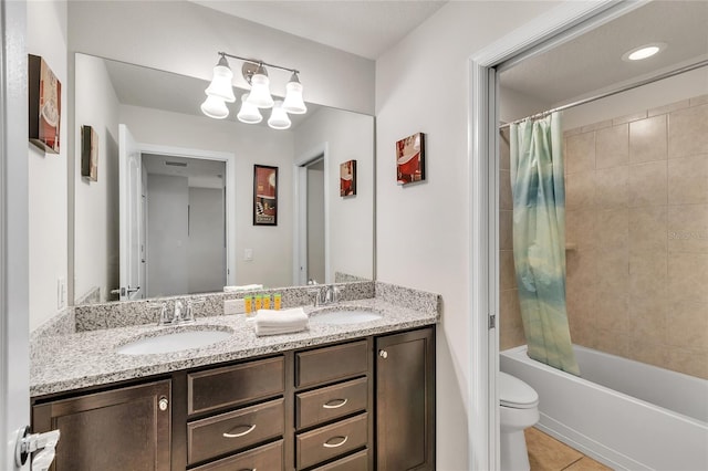 full bathroom featuring double vanity, tile flooring, shower / bath combo with shower curtain, and toilet