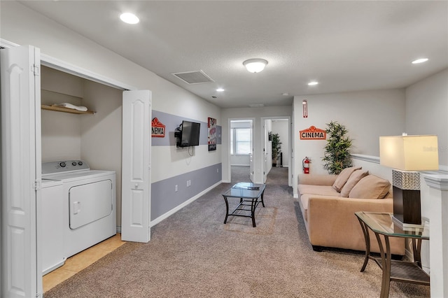 carpeted living room featuring a textured ceiling and washer / clothes dryer