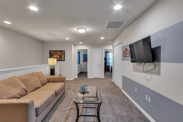 living room with light colored carpet and a textured ceiling