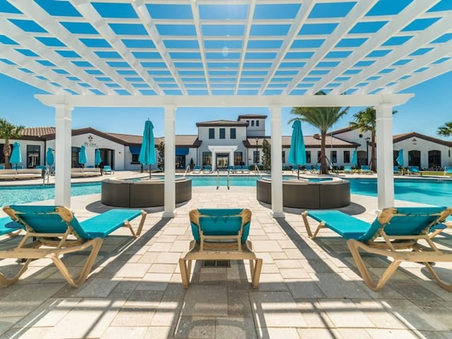 view of patio / terrace featuring a community pool and a pergola