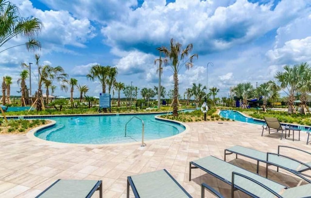 view of swimming pool with a patio