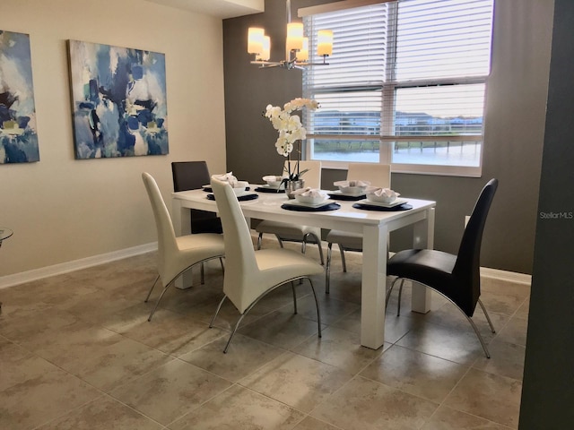 tiled dining space featuring an inviting chandelier