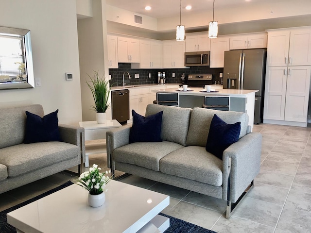 living room featuring sink and light tile floors