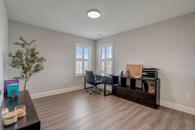 office featuring wood-type flooring and a textured ceiling