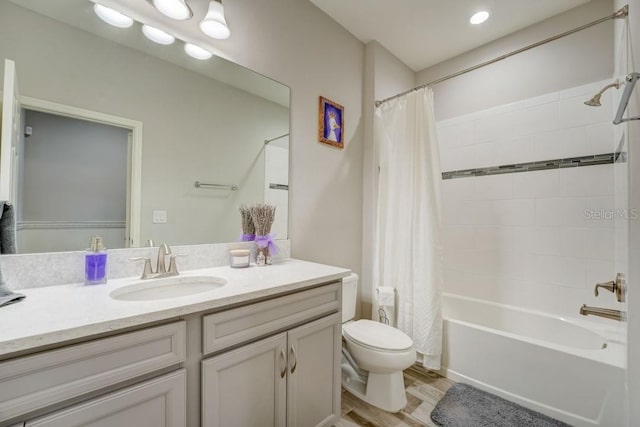 full bathroom featuring hardwood / wood-style floors, shower / tub combo, vanity, and toilet