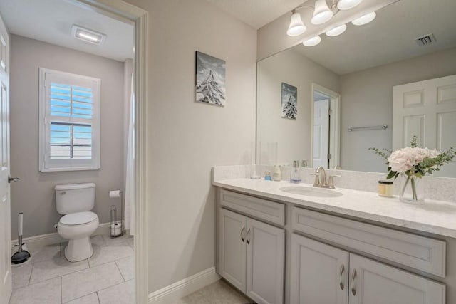 bathroom featuring toilet, oversized vanity, and tile flooring