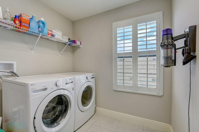 clothes washing area featuring independent washer and dryer, light tile floors, and hookup for a washing machine