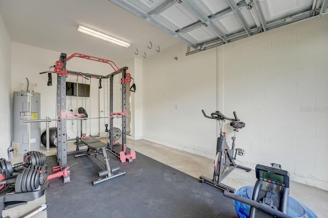 workout area featuring concrete floors and electric water heater