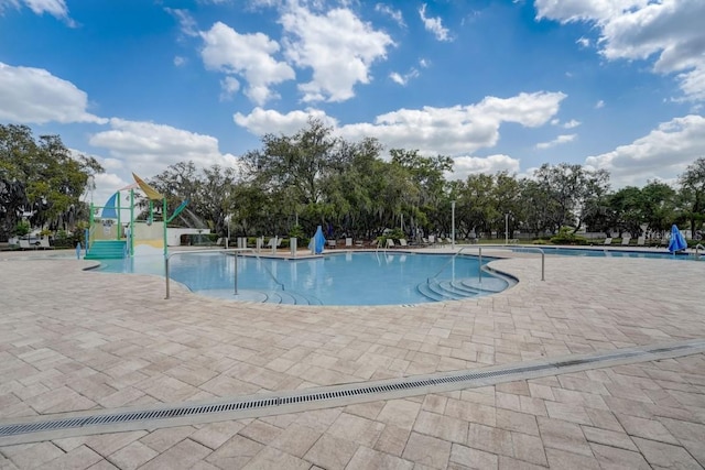 view of swimming pool with a patio area