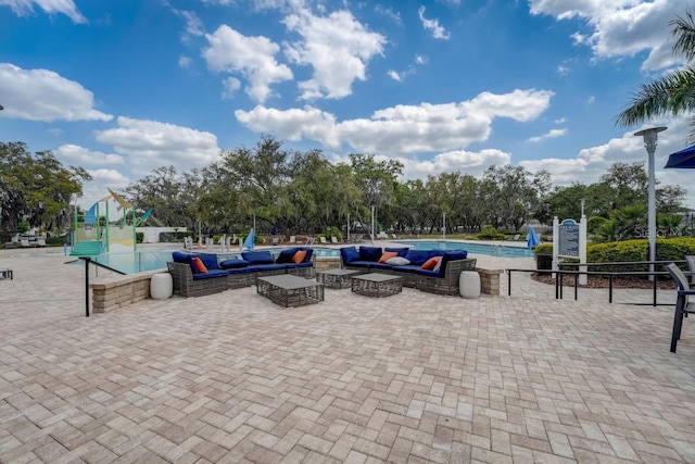 view of property's community featuring a patio area and a swimming pool