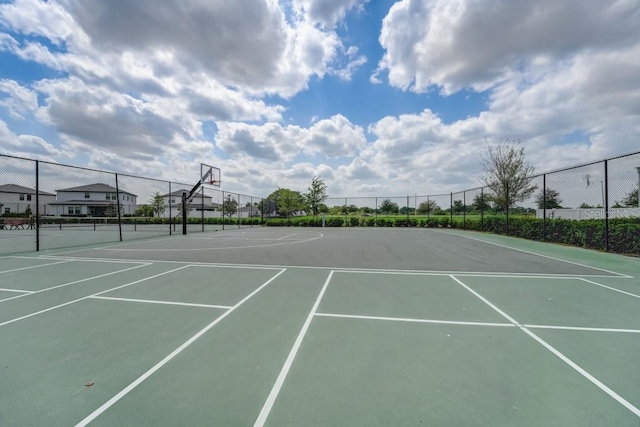 view of tennis court featuring basketball hoop