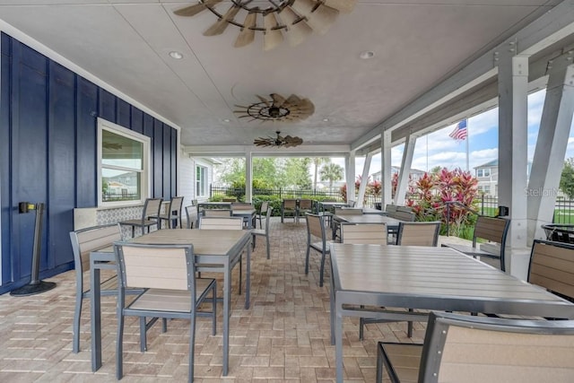 sunroom / solarium featuring ceiling fan