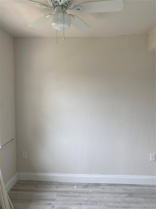 empty room with light hardwood / wood-style floors and ceiling fan