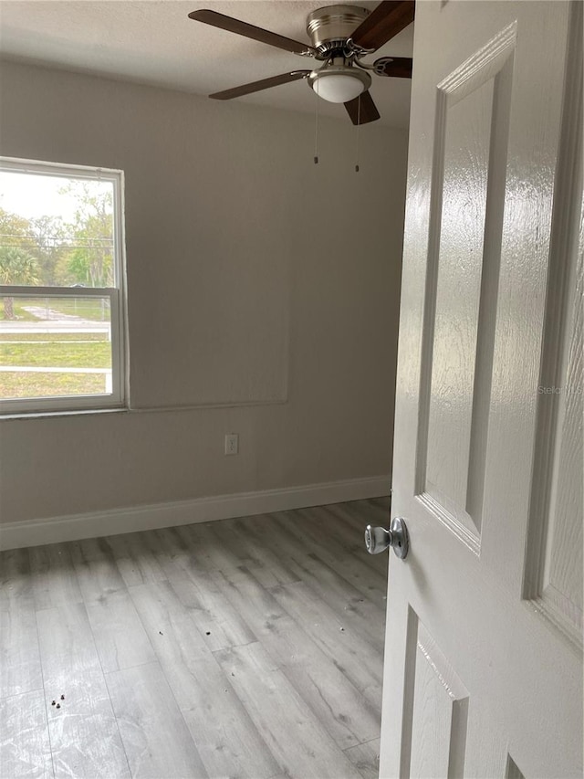 unfurnished room with light hardwood / wood-style floors and ceiling fan