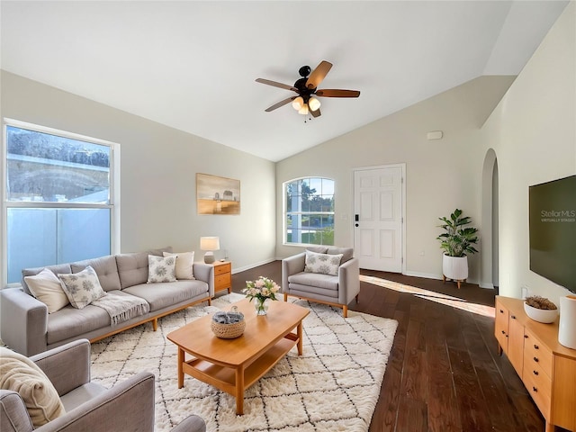 living room with ceiling fan, dark wood-type flooring, and vaulted ceiling